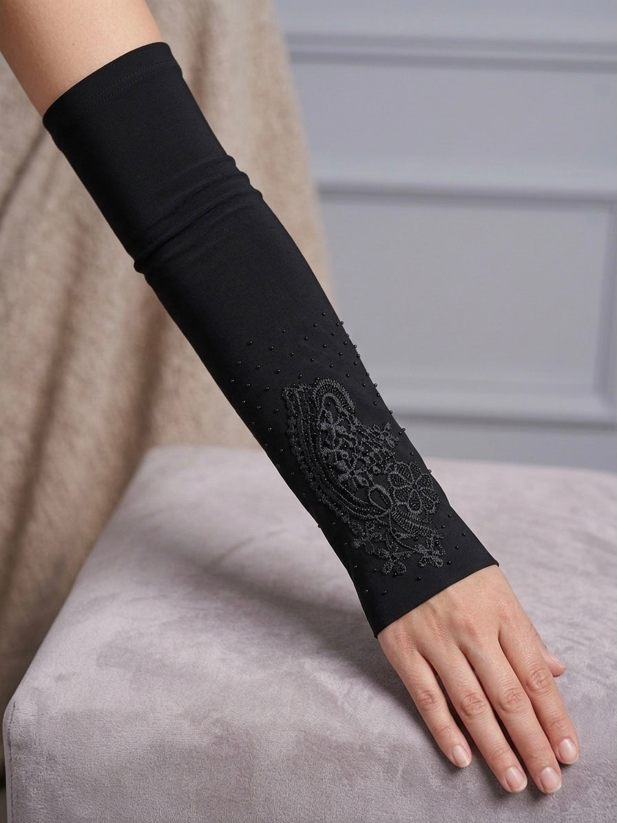 Embellished black arm sleeves with floral and rhinestone detailing