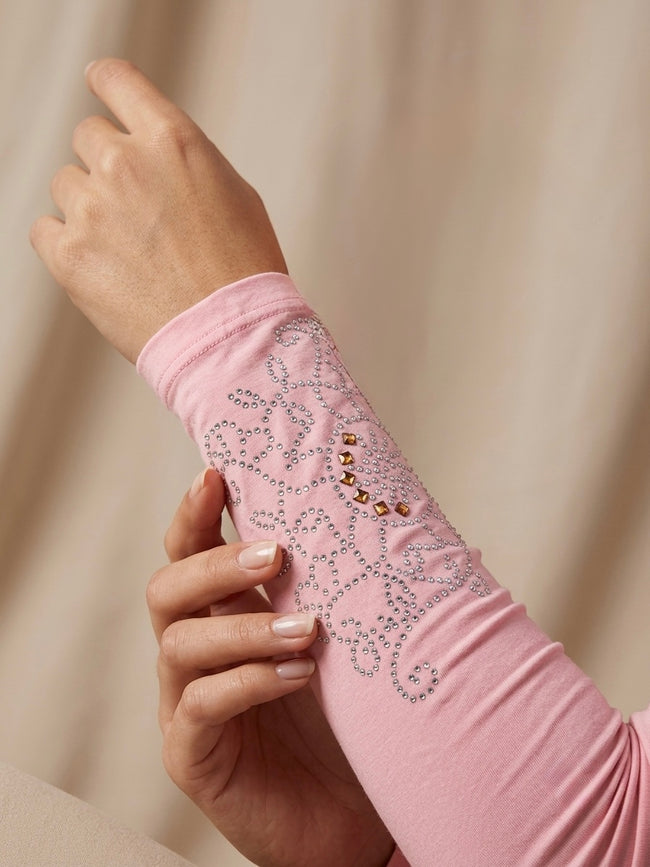 Embellished pink arm sleeves with silver rhinestone and gold detailing Hover Image